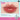 Little Ondine Rose Rhapsody lip color tube with applicator beside a glossy lip swatch