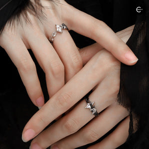 A Part Of Me sterling silver ring with dove and crow motifs worn on two hands