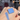 Shellwe Makeup Confess single eyeshadow pan in blue, shown on a hand beside a matching swatch