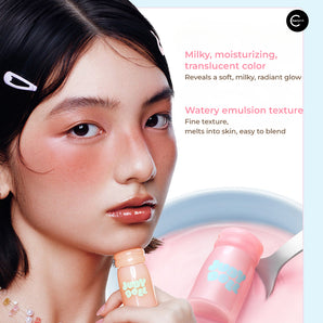 JUDYDOLL Milky Blush Liquid shown in hand beside a model's cheek