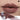 ANTHEMY Erosion Matrix Lip Gloss in #M02 Acid Rain, gray nude shade shown on lips with applicator