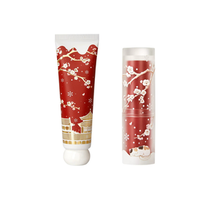 The Palace Museum Palace Snow hand cream tube and lip balm stick with red floral packaging, shown side by side
