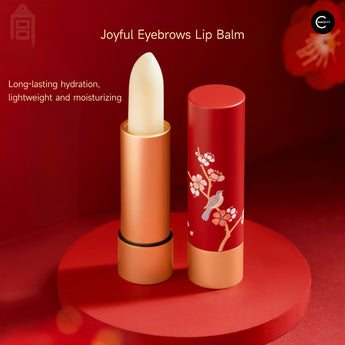 The Palace Museum Joyful Eyebrows lip balm in an open gold tube beside a red plum blossom and magpie cap