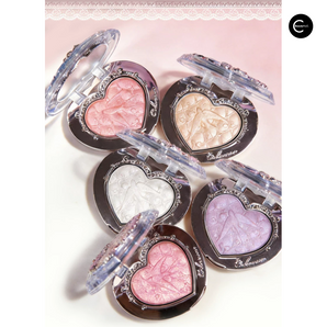 Five heart-shaped makeup compacts in pink, gold, white, lavender, and rose shades