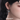 DOACH STYLE silver spider earring with blue eye detail, close-up on-model side view
