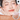 SPENNY compact cheek color in shade 927 Melon Honey beside a model wearing a warm tangerine flush